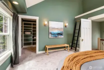 Bedroom with large walk in closet with built in shelving.