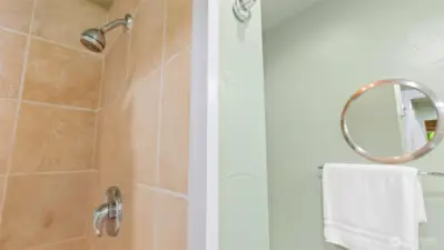 The primary ensuite also showcases sleek chrome fixtures for a clean, modern finish.