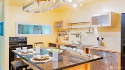 Wow! Renovations opened up the entire space by removing walls and adding this stunning kitchen island. Say goodbye to a closed-off kitchen and hello to effortless flow and functionality.
