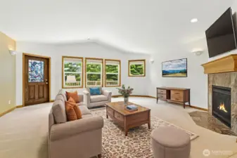 The living room offers direct access to the back deck through a convenient door, perfect for seamless indoor-outdoor living.(virtually staged)