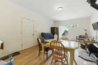 Spacious recreation room featuring a cozy wood stove and a convenient ¾ bathroom—perfect flex space.