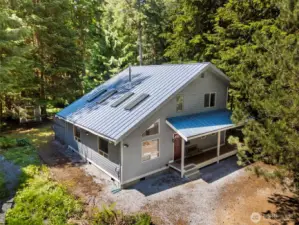 Welcome to this charming home nestled among evergreens with modern roofline and private setting.