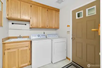 Laundry/mudroom with cabinet storage.