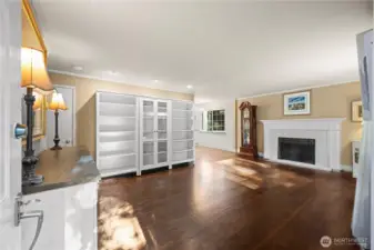 Spacious living room with beautiful oak hardwood floors, lots of natural light & fireplace.