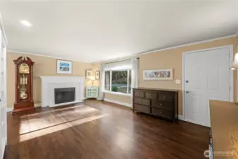 Spacious living room with beautiful oak hardwood floors, lots of natural light & fireplace.