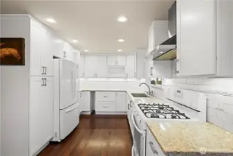 Updated kitchen with floor to ceiling cabinets, quartz counter tops & dual fuel gas range.