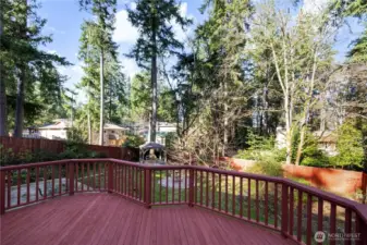 Large deck off the dining room overlooks beautiful, fully fenced backyard oasis.