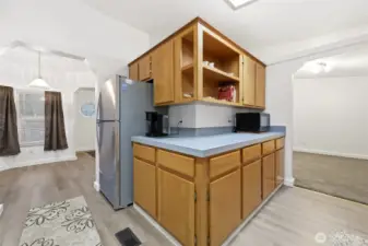 View of kitchen with breakfast nook to the left, and dining room to the right.