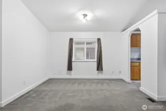 Dining area with kitchen to the right.
