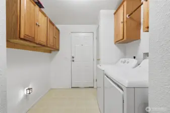 Laundry room with exit door to side of house. Newer appliances.