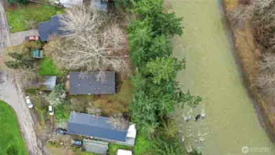 Middle home with high bank lot.