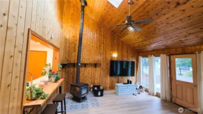 Large family room with wood stove and ceiling fan