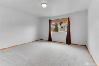 Primary bedroom with walk in closet, new carpet, and en-suite bathroom!