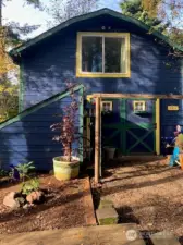 The detached garage with a loft area above and a kitchen/great room area and full bathroom downstairs.