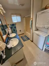 Large full bathroom/utility room off the kitchen.