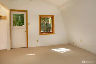 Upper bedroom with closet & balcony access.