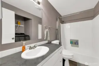 Large main bathroom with tub and shower plus storage.