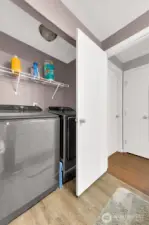 Washer and dryer with storage and hanging shelf.