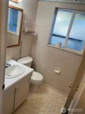 Full bathroom has sink vanity with  medicine cabint and three panel mirror lights above. Toilet is heated with Bidet.