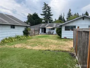 View of Backyard, North side of house, patio, rear entrance,  West side of shop from the Back Fence.