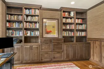 Full wall of built-ins with filing cabinets.