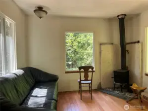 Sunny livingroom with wood stove.