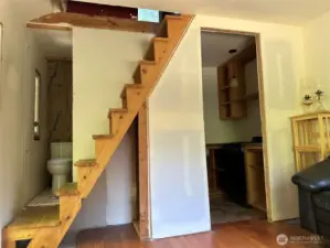 Unfinshed bath room. Basic kitichen. Stairway to upper floor.