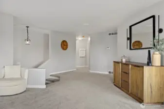 Spacious and inviting open-concept layout with neutral tones, soft carpet, and modern fixtures. The flexible floorplan allows for both formal and casual living arrangements.