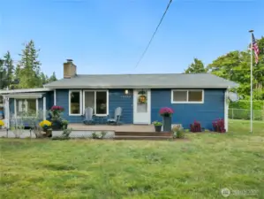 Charming blue home with white trim and a welcoming front porch.