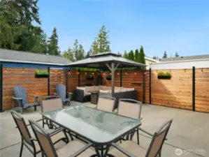 Spacious concrete patio with a cozy gazebo, dining table for six great for entertaining or relaxing.
