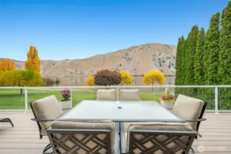 Panoramic river and hillside views from the spacious upper deck, perfect for outdoor dining and relaxation.