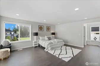 Master bedroom with his and her walk-in closets