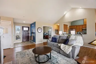 Living room looking toward front door and kitchen