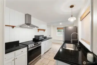 Stunning kitchen with granite counters and stainless-steel appliances.