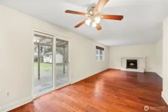 Family room features a wood burning fireplace with brick surround and wood mantle for ambiance and those chilly nights.