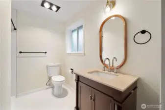 Primary bath with updated vanity and tile floors.
