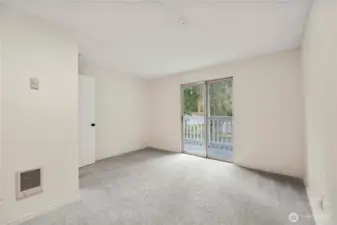 Another view of the bonus room featuring a slider leading to the balcony.