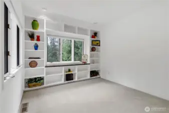 Office with bookcase and seating area.