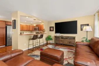 View of large family room and kitchen with breakfast bar.