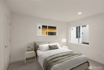 This image is virtually staged. A third generously sized bedroom with dual windows and soft, neutral tones.