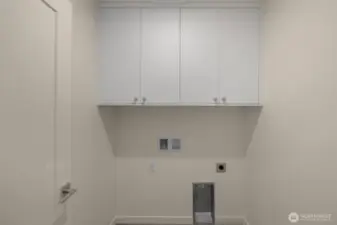 Tucked away, your laundry room includes upper cabinets and hookups for a side-by-side washer/dryer.