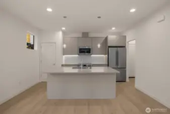 A chef’s dream! This expansive kitchen features a quartz-topped island, sleek cabinetry, and premium appliances ready to elevate your meals.