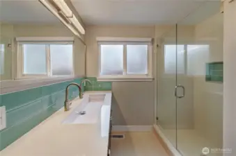 Main bath with slab quartz, elongated sink, dual faucets