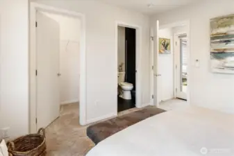 Primary bedroom features a large walk in closet and bathroom.