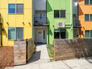Fully fenced front yard leading to the townhouse. Unit features a mini-split air conditioning system.