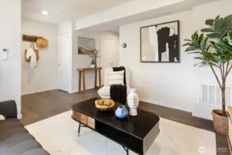 Living room with front entry in the background.