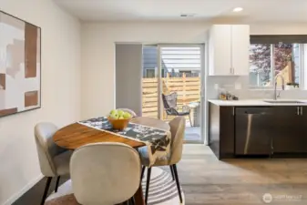 Another look at the dining area, patio and kitchen.