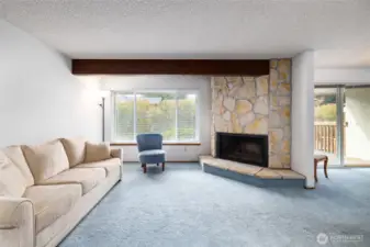 This wood beam and fireplace combo is charming!