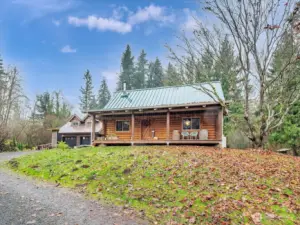 Log home in foreground. Garage/shop with MIL unit in background