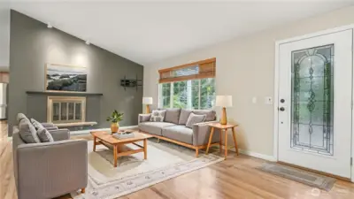 Spacious living room with cozy wood burning fireplace. *Virtually Staged*